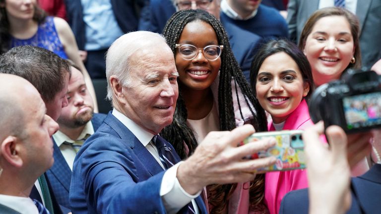 U.S. President Joe Biden takes a selfie with students on the 25th anniversary of the Belfast/Good Friday Agreement, at Ulster University, Belfast, Northern Ireland April 12, 2023. REUTERS/Kevin Lamarque
