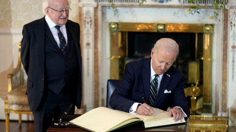President Joe Biden signs the guest book as he meets with Irish President Michael Higgins at Aras an Uachtarain, Thursday, April 13, 2023, in Dublin. (AP Photo/Patrick Semansky)