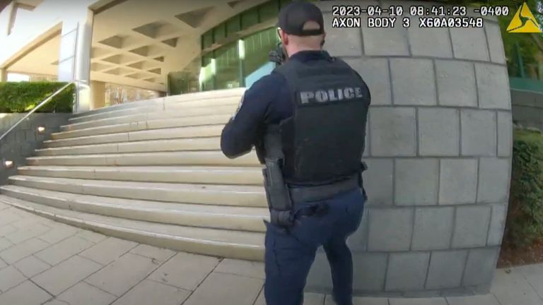 In this screen grab taken from the body cam video of Louisville Metro Police Department Officer Nickolas Wilt, fellow Officer Cory Galloway approaches an active shooting situation, with Wilt following behind him, at Old National Bank, in Louisville, Ky., Monday, April 10, 2023. (Louisville Metro Police Department via AP)