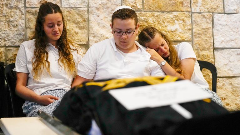 Children of Lucy Dee mourn during her funeral at a cemetery in the West Bank settlement of Kfar Etzion, Tuesday, April 11, 2023. The British-Israeli woman died of wounds suffered in an April 7 shooting by Palestinian gunmen in the West Bank that also killed her daughters, Maia and Rina Dee. (AP Photo/Maya Alleruzzo)