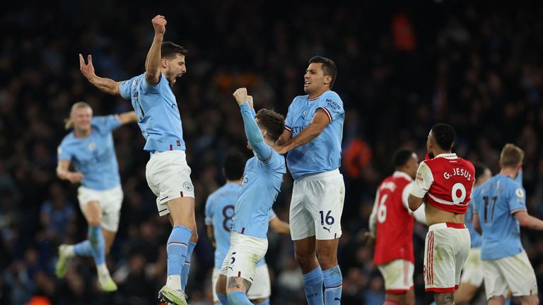 Manchester City players celebrate scoring against Arsenal