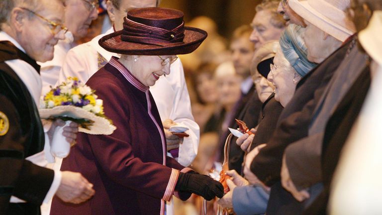Traditional Maundy gift purses containing minted coins were handed to 78 men and 78 women in the 2004 Maundy Service. Pic: AP