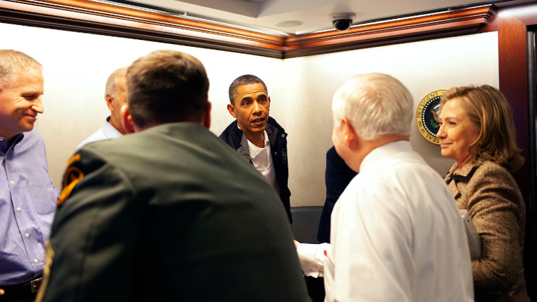 Mr. Obama shakes hands with the team before leaving the waiting room.Photo: Obama Presidential Library