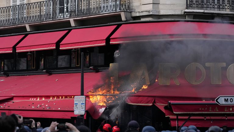 The awning of the La Rotonde restaurant burns during  the demonstration 
Pic:AP