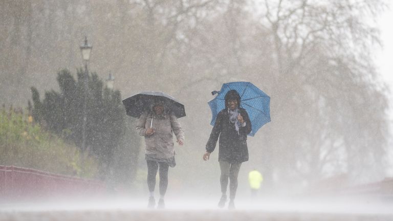 People brave the rainy conditions in Battersea Park, London, on Easter Monday, after a warm spell of weather earlier over the Easter weekend has come to an end. Picture date: Wednesday April 5, 2023.
