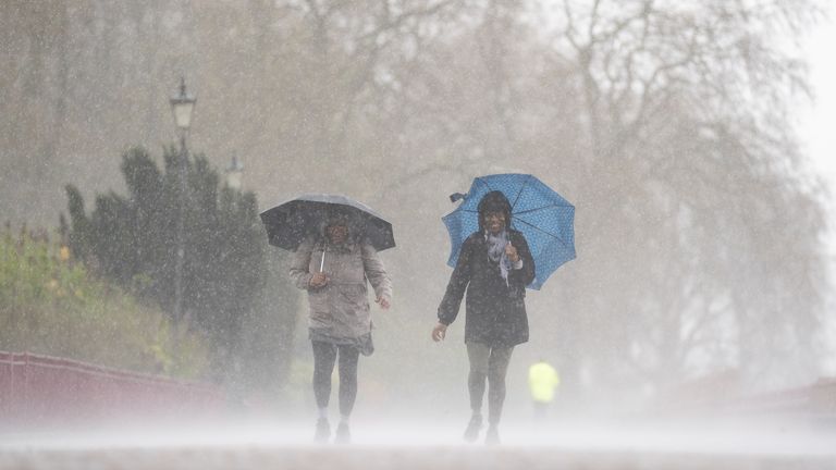 People brave the rainy conditions in Battersea Park, London, on Easter Monday, after a warm spell of weather earlier over the Easter weekend has come to an end. Picture date: Wednesday April 5, 2023.
