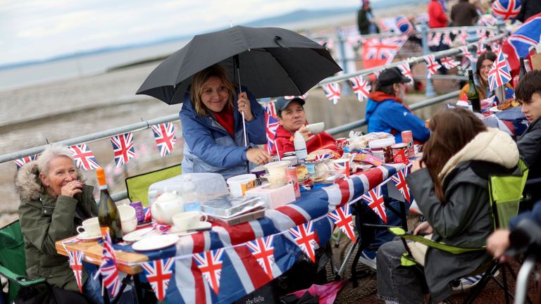 Lots of street parties were also organised for the Queen&#39;s Platinum Jubilee last year 

A woman holds an umbrella as people attend the Morecambe Town Council street party amid celebrations marking the Platinum Jubilee of Britain&#39;s Queen Elizabeth, on Morecambe Promenade in Morecambe, Britain, June 5, 2022. REUTERS/Carl Recine

