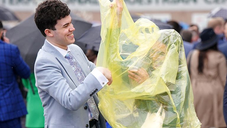 Racegoers in ponchos during day two of the Randox Grand National Festival at Aintree Racecourse, Liverpool. Picture date: Friday April 14, 2023.