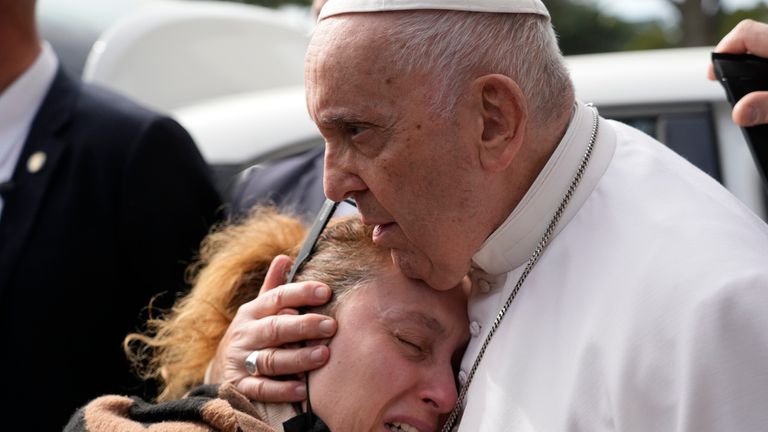 Pope Francis consoles a couple who as lost a child the day before as he leaves the Agostino Gemelli University Hospital in Rome, Saturday, April 1, 2023 after receiving treatment for a bronchitis, The Vatican said. Francis was hospitalized on Wednesday after his public general audience in St. Peter&#39;s Square at The Vatican. (AP Photo/Gregorio Borgia)