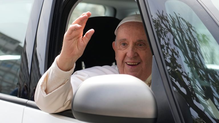 Pope Francis waves from his car as he leaves the Agostino Gemelli University Hospital in Rome, Saturday, April 1, 2023 after receiving treatment for a bronchitis, The Vatican said. Francis was hospitalized on Wednesday after his public general audience in St. Peter&#39;s Square at The Vatican. (AP Photo/Gregorio Borgia)