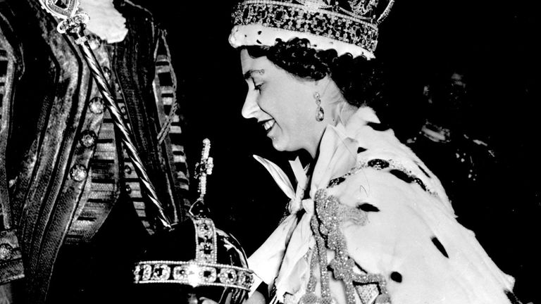The Queen carries the orb after her coronation in 1953