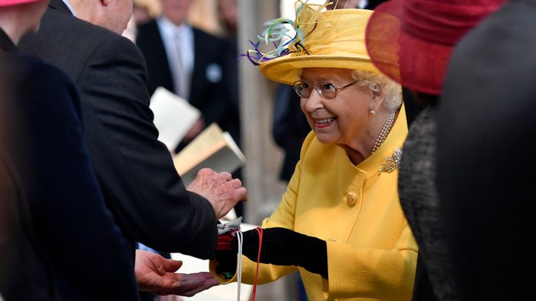  Queen Elizabeth greets well-wishers and hands out  Maundy money at St George&#39;s Chapel in Windsor, in 2019.  Pic: AP