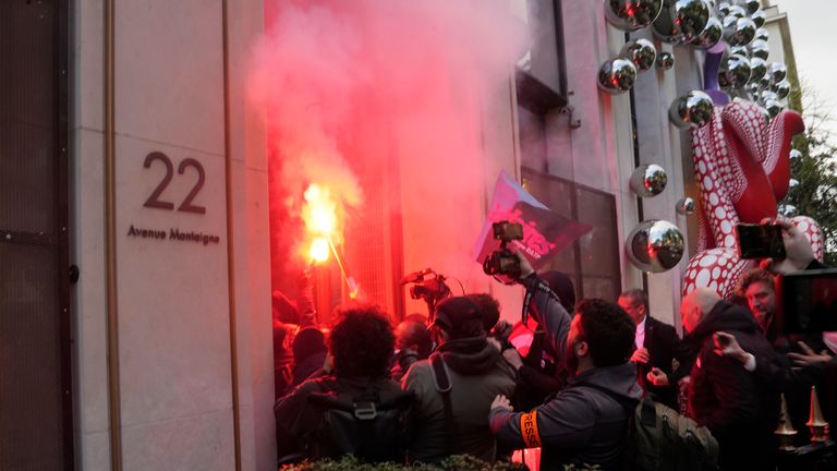 Reporters follow striking railway workers invading LVMH headquarters in Paris Pic: AP 