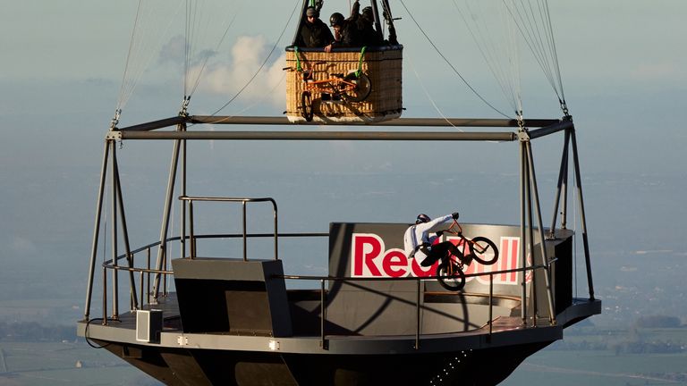 Red Bull undated handout photo of Kriss Kyle, a BMX rider, performing tricks on a floating skatepark in the Cotswolds more than 2,000 feet (609 meters) above the ground. Release date: Thursday, April 13, 2023.