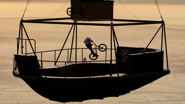 Undated handout photo issued by Red Bull of Kriss Kyle, a BMX rider performing tricks on a floating skatepark more than 2,000 feet (609 metres) above the ground in the Cotswolds. Issue date: Thursday April 13, 2023.