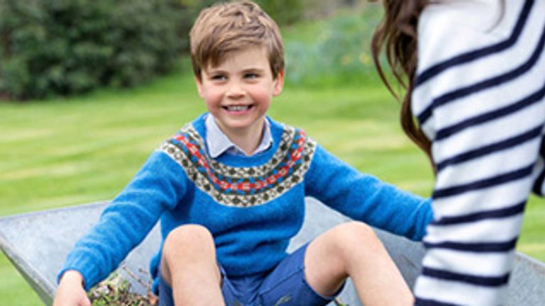 A smiling Prince Louis being pushed in a wheelbarrow by his mother, the Princess of Wales, ahead of his fifth birthday