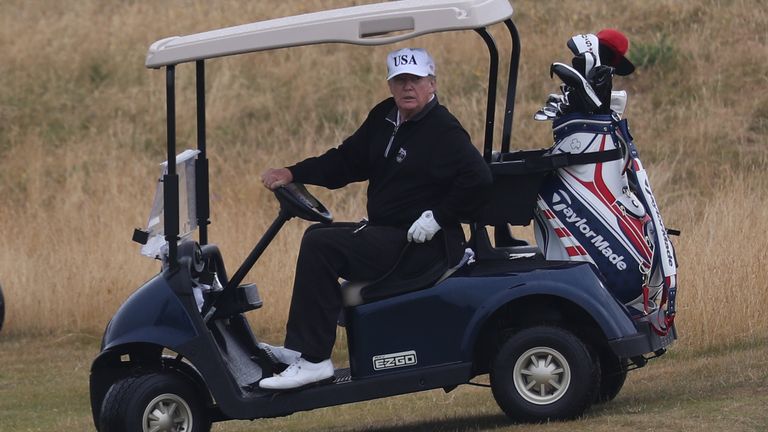 US President Donald Trump drives a golf buggy on his golf course at the Trump Turnberry resort in South Ayrshire, where he and his wife Melania, spent the weekend as part of their visit to the UK before leaving for Finland where he will meet Russian leader Vladimir Putin for talks on
