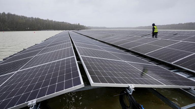 FILE - Solar panels are installed at a floating photovoltaic plant on a lake in Haltern, on Friday, April 1, 2022. Long periods of sunshine took solar power generation in Europe to a record high this summer, helping reduce the need for gas imports, according to a report Thursday. Energy think tank Ember said the European Union generated 12% of its electricity from solar power from May to August, up from 9% during the same period last year. (AP Photo/Martin Meissner, File)
