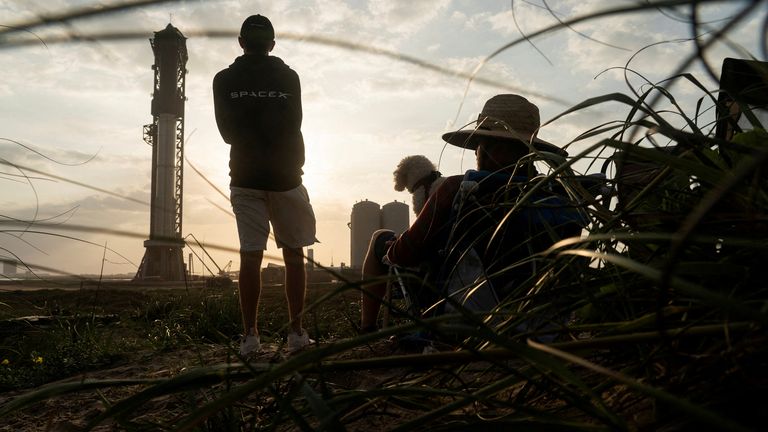 Spectators watch the SpaceX Starship on its Boca Chica launchpad following a postponement in its launch date due to a frozen valve, after the U.S. Federal Aviation Administration granted a long-awaited license allowing Elon Musk&#39;s SpaceX to launch the rocket to orbit for the first time, near Brownsville, Texas, U.S. April 18, 2023. REUTERS/Go Nakamura TPX IMAGES OF THE DAY
