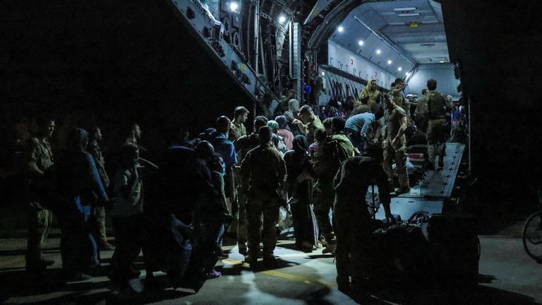 British nationals board an RAF plane during the evacuation from Wadi Seidna Air Base