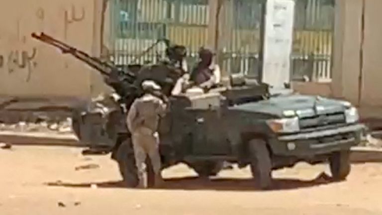 A military vehicle and soldiers are seen on a street of Khartoum, Sudan, April 15, 2023 in this scren grab obtained from a social media video. Mohammadkhair Abdualrhman/via REUTERS THIS IMAGE HAS BEEN SUPPLIED BY A THIRD PARTY. MANDATORY CREDIT. NO RESALES. NO ARCHIVES.