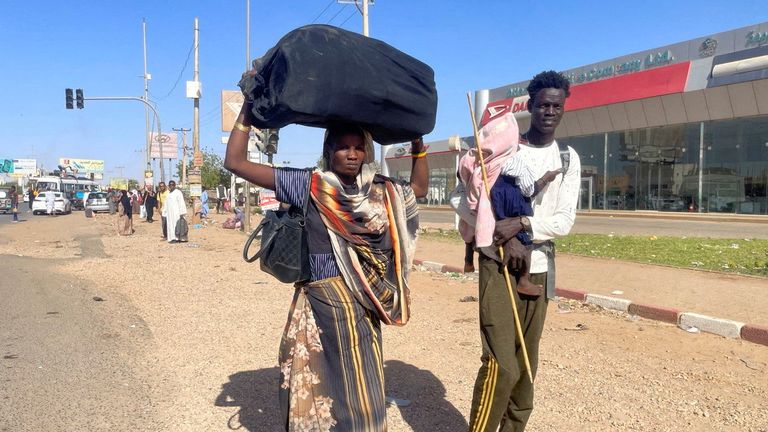 People prepare to flee the capital Khartoum during the clashes