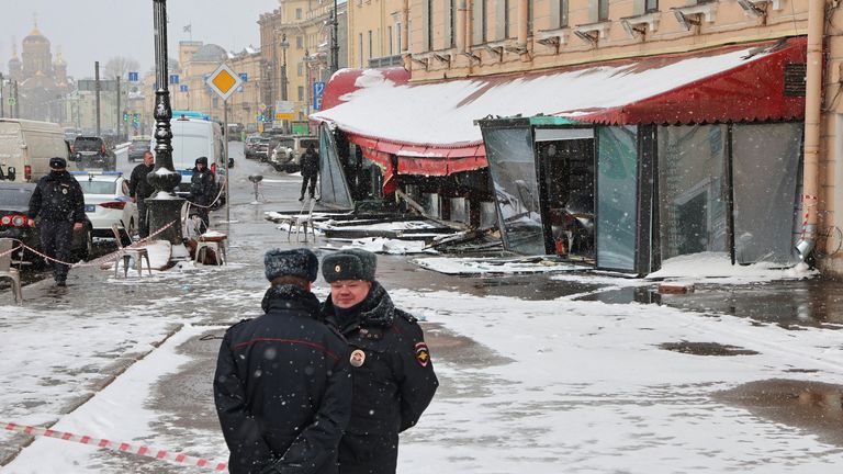 Police officers stand guard at the scene of the cafe explosion in which Russian military blogger Vladlen Tatarsky  was killed