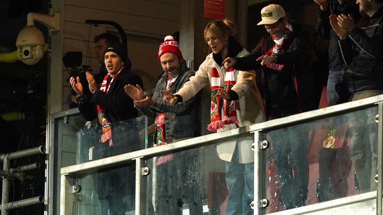 Wrexham co-owner Rob McElhenney (left), Charlie Day, Kaitlin Olson, and Glenn Howerton celebrate after the final whistle in the Vanarama National League match at The Racecourse Ground, Wrexham. Picture date: Tuesday April 18, 2023. Pic: PA