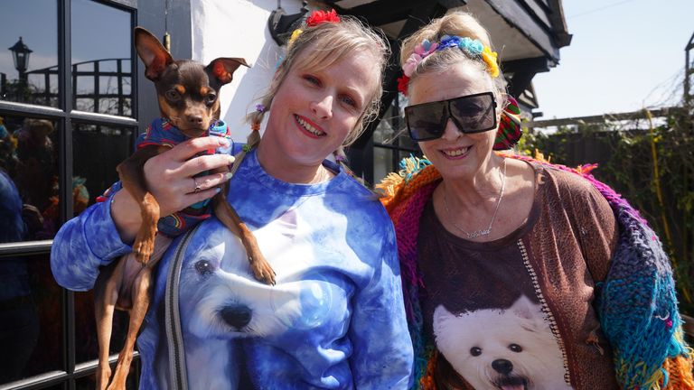 Fleur Boyd (left) with her mother Astrid Allen from Margate with their dog Zeus outside the Walnut Tree Pub in Aldington, Kent, as they wait for Paul O&#39;Grady&#39;s funeral cortege to travel through the village of Aldington, Kent, ahead of his funeral at St Rumwold&#39;s Church. Picture date: Thursday April 20, 2023.
