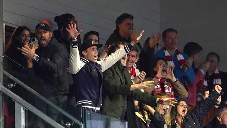 The Wrexham co-owners celebrate their side's third goal during the match  