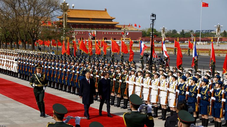 Chinese President Xi Jinping and French President Emmanuel Macron review troops during an official ceremony at the Great Hall of the People, in Beijing, China, April 6, 2023. REUTERS/Gonzalo Fuentes

