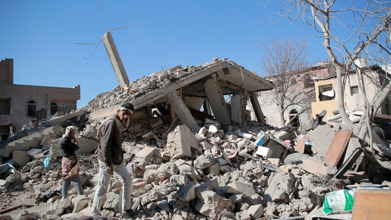 Yemeni people inspect a damaged building at the site of a Saudi-led air strike on Sanaa. Pic: AP