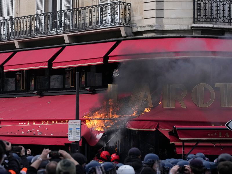 Railway workers invade Louis Vuitton HQ as protests erupt across France on  eve of decision on retirement age, World News
