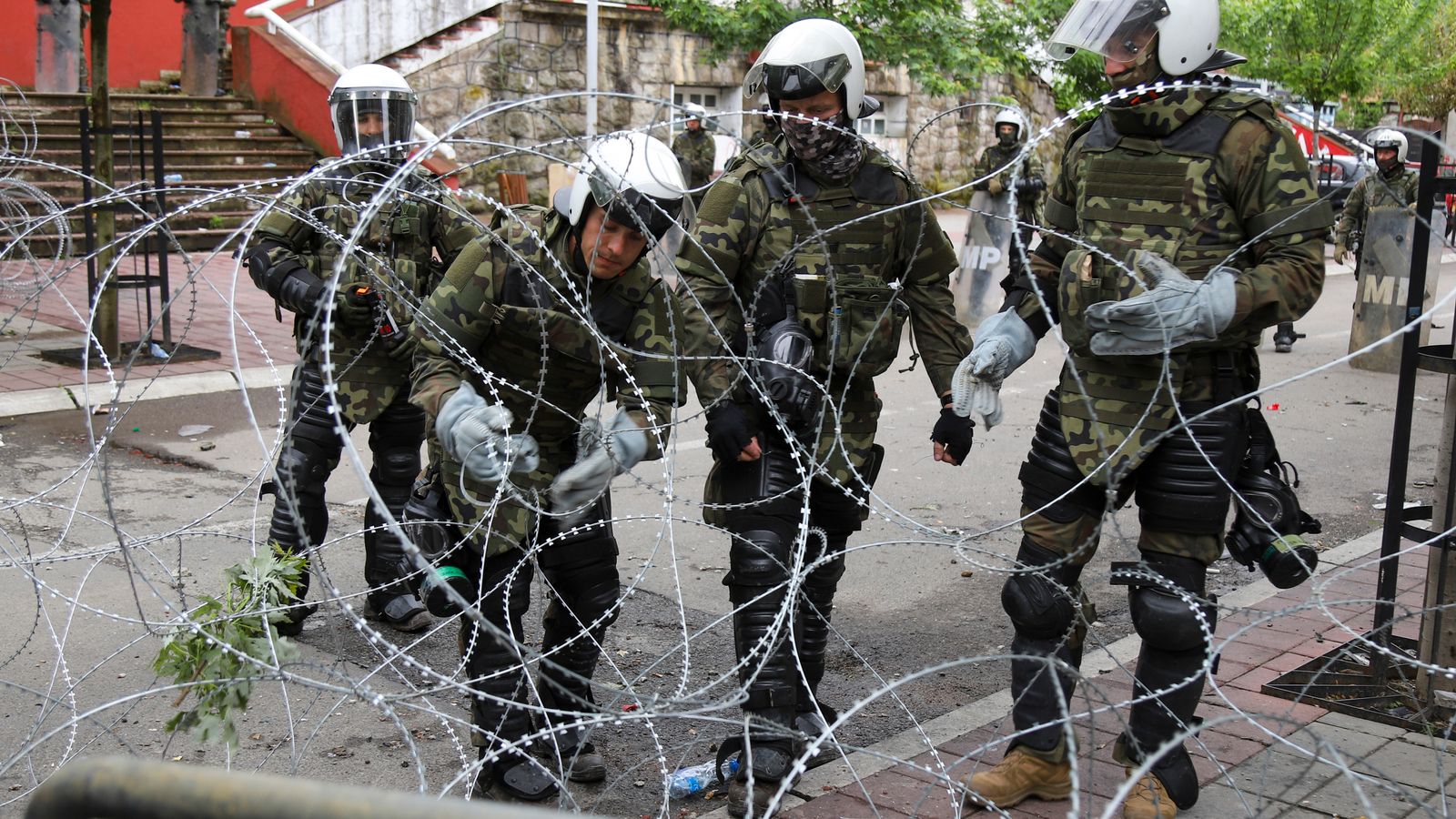 Kosovo clashes: NATO-led troops put up barbed wire barriers after protests in northern towns 