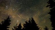 A meteor streaks across the sky during the annual Perseid meteor shower in 2021. 