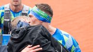 Kevin Sinfield kisses Rob Burrow as he carries him across the finish line of the 2023 Rob Burrow Leeds Marathon which started and finished at Headingley Stadium, Leeds. Picture date: Sunday May 14, 2023.