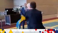 Russian and Ukrainian delegates fight after the former removes a flag