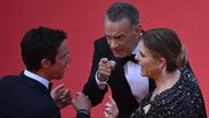 US actor Tom Hanks (C) and US actress Rita Wilson speak with a staff member as they arrive for the screening of the film "Asteroid City" during the 76th edition of the Cannes Film Festival in Cannes, southern France, on May 23, 2023. (Photo by Antonin THUILLIER / AFP) (Photo by ANTONIN THUILLIER/AFP via Getty Images)