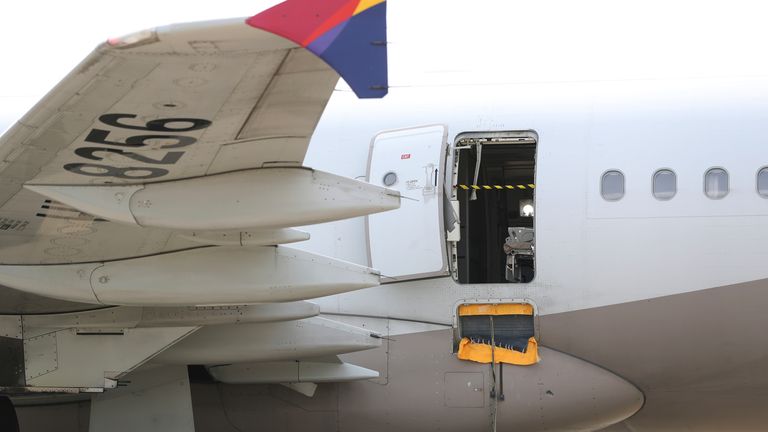 An Asiana Airlines plane is parked as one of the plane&#39;s doors suddenly opened at Daegu International Airport in Daegu, South Korea,
Pic:AP