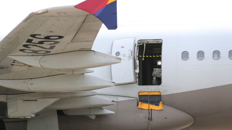 An Asiana Airlines plane is parked as one of the plane&#39;s doors suddenly opened at Daegu International Airport in Daegu, South Korea,
Pic:AP