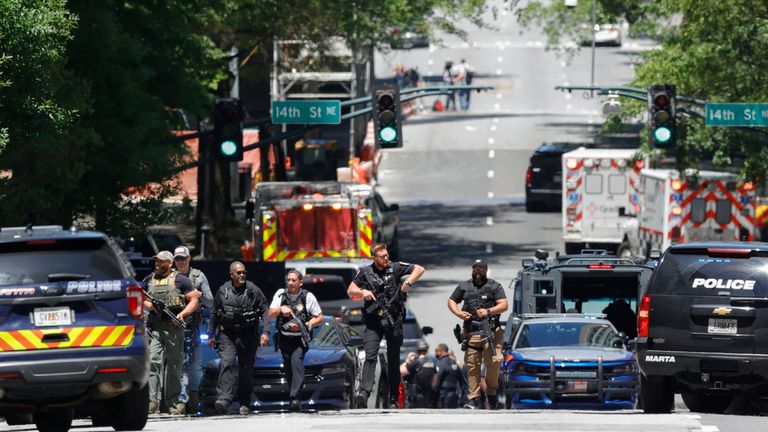 Law enforcement officers stage near the scene of an active shooter on Wednesday, May 3, 2023 in Atlanta. Atlanta police said there had been no additional shots fired since the initial shooting unfolded inside a building in a commercial area with many office towers and high-rise apartments.   (AP Photo/Alex Slitz)
