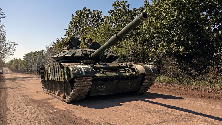 Ukrainian servicemen ride atop a tank on a road towards the frontline town of Bakhmut, amid Russia's attack on Ukraine, in Donetsk region, Ukraine May 12, 2023. REUTERS/ Sofia Gatilova