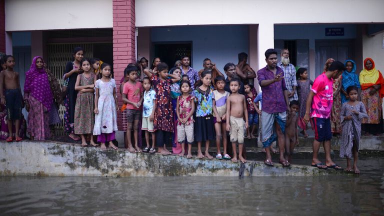 Displaced people stand outside a temporary shelter in Sunamganj, Bangladesh in June 2022 Pic: AP 