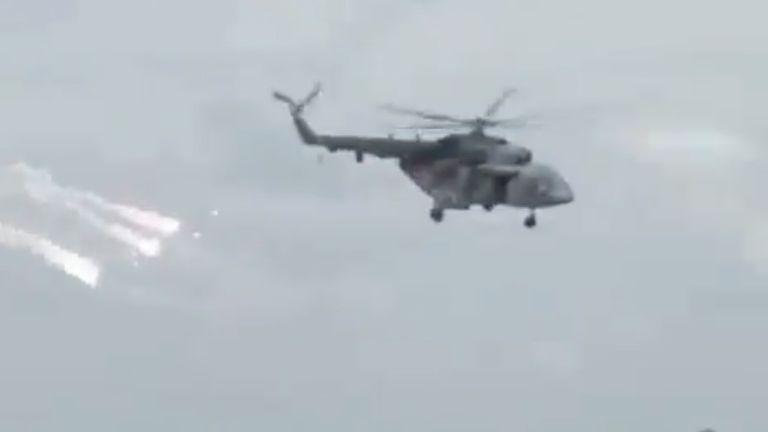 Still from video of helicopter launching flares