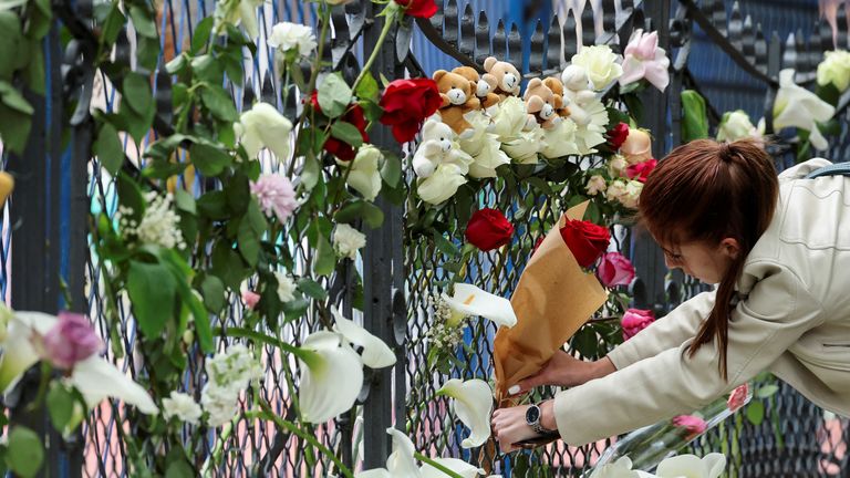 A woman leaves flowers as she pays tribute following a school mass shooting, after a boy opened fire on others, killing fellow students and staff in Belgrade, Serbia, May 4, 2023. REUTERS/Antonio Bronic