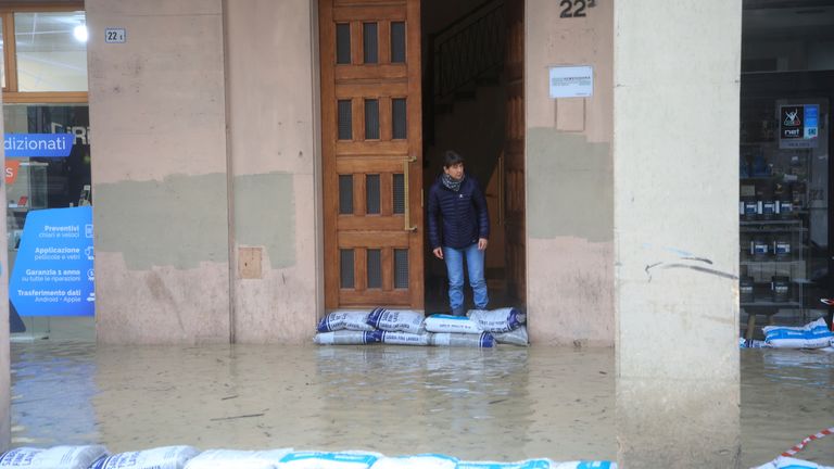 Sandbags are lined up along a flooded street in Bologna, Italy,
Pic:LaPresse /AP
