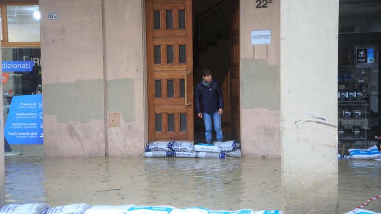 Sandbags are lined up along a flooded street in Bologna, Italy,
Pic:LaPresse /AP