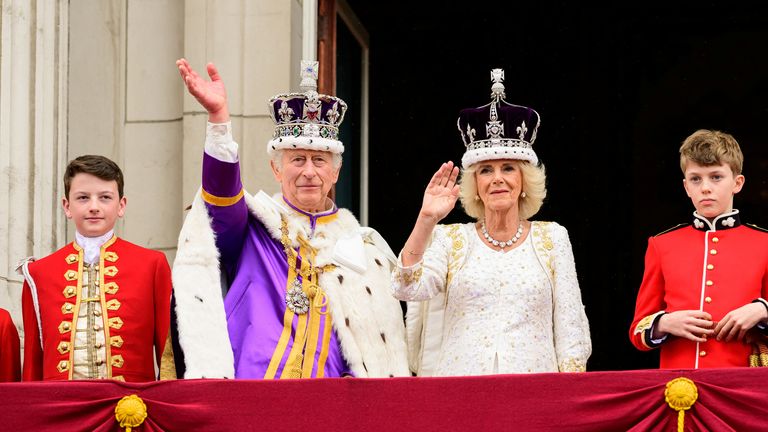 King Charles II and Queen Camilla wave from the balcony of Buckingham Palace during the Coronation 