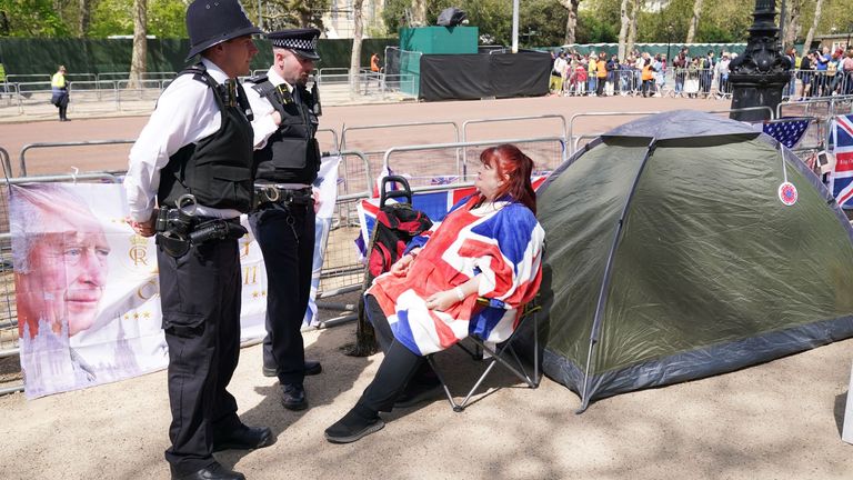 Police officers have a friendly chat with royal fan Faith Nicholson, who is camping out on The Mall, near Buckingham Palace in central London, ahead of the coronation of King Charles III on Saturday May 6. Picture date: Wednesday May 3, 2023.