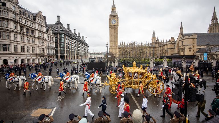 The Gold State Coach progresses through London, pulled by eight Windsor greys